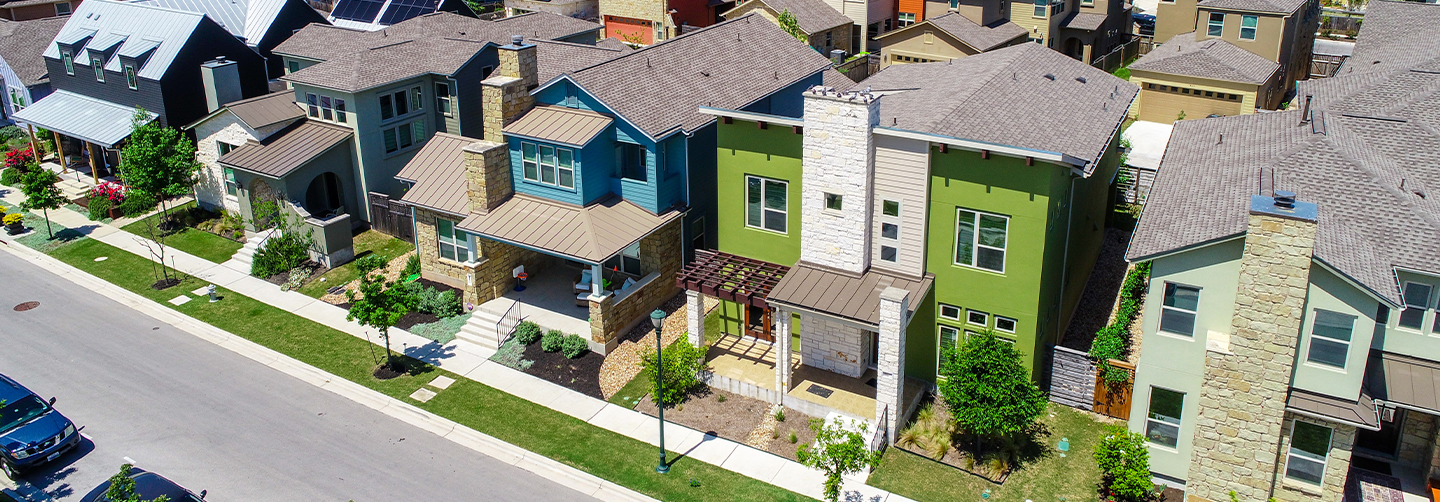 Green and blue and colorful houses facade Aerial drone view of suburb neighborhood in East Austin community houses and homes - Mueller Suburb Solar Panel Rooftops and Modern Austin Living
